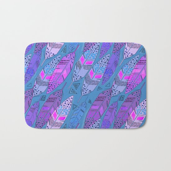 The colorful feathers on blue background . Bath Mat
