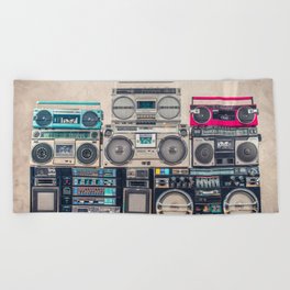 Retro old school design ghetto blaster stereo radio cassette tape recorders boombox tower from circa 1980s front concrete wall background. Vintage style filtered photo Beach Towel