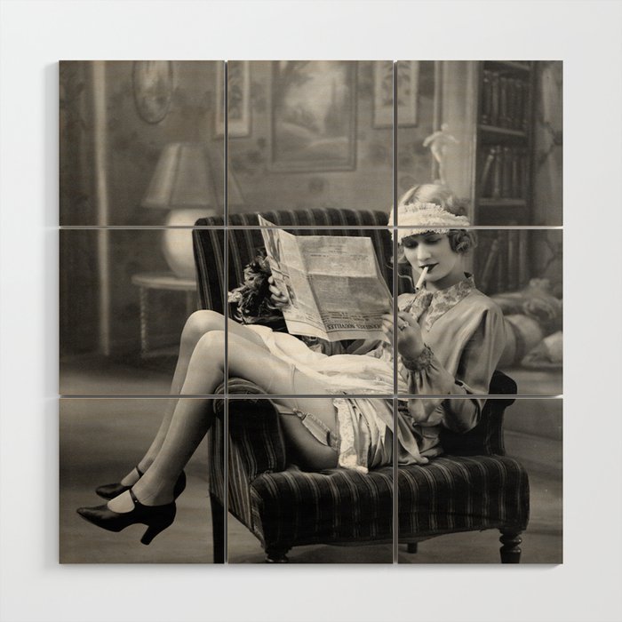 The funny papers; roaring twenties flapper in garter belt and stockings reading newspaper and smoking cigarette portrait black and white vintage photograph - photography - photographs Wood Wall Art