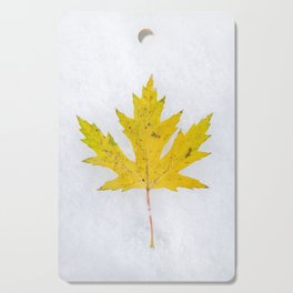 Yellow Maple Leaf on Snow Cutting Board