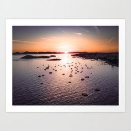 Dramatic sunset on the sea coast with boats in the sea Art Print