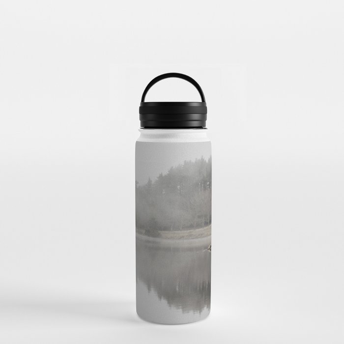 misty morning on the lake Water Bottle