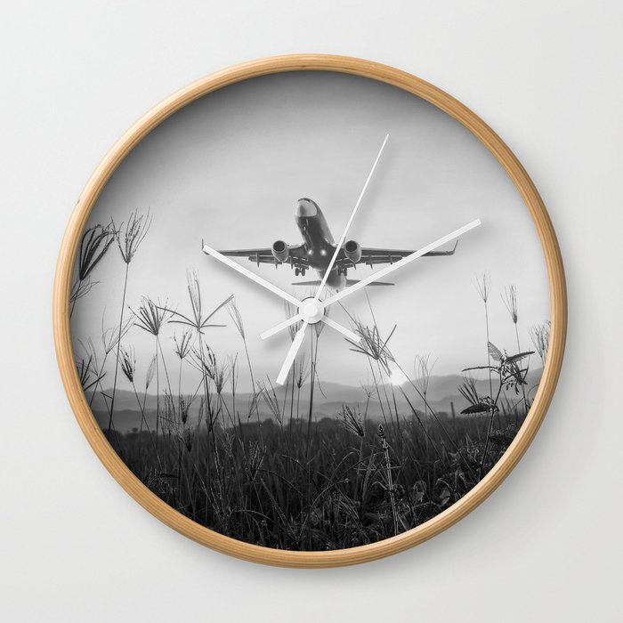To places unknown ... perfect airplane takeoff from tropical mountain coastal setting black and white photograph - photography - photographs Wall Clock