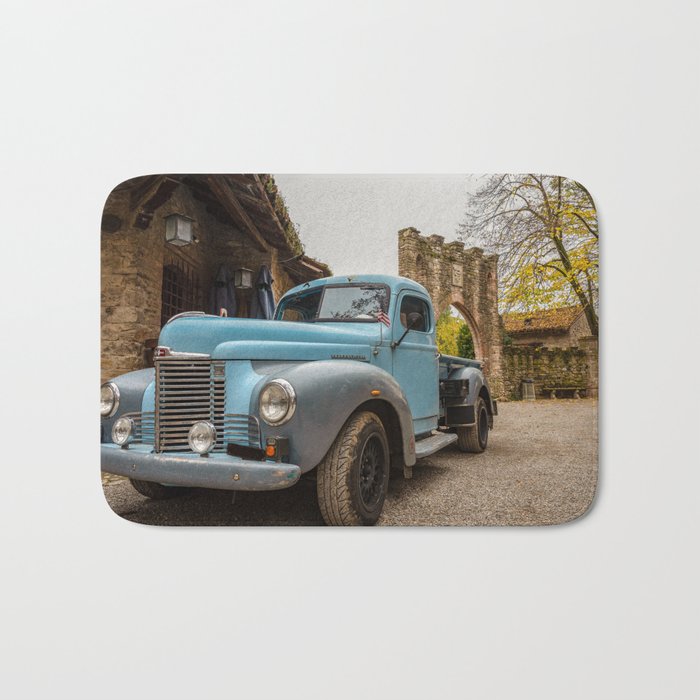 Historic blue-colored pickup parked in the streets of an historic Italian village Bath Mat