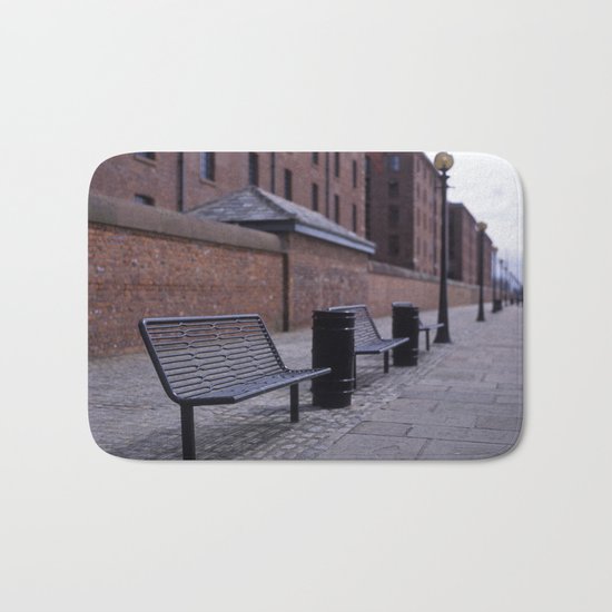a row of benches Bath Mat