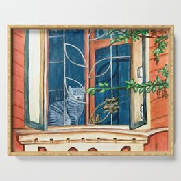 lovely cat is sitting on the window of an old house Serving Tray