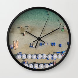 Blue and white umbrellas at a beach in the Cinque Terre, Italy Wall Clock