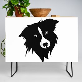 Portrait of a funny playful black and white border Collie puppy. A rough plan. Shepherd dog, smart friend black and white. Credenza