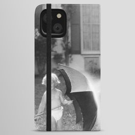Always look on the bright side of life; little girl thwarting father with hose using umbrella humorous funny black and white photograph - photography - photograph iPhone Wallet Case