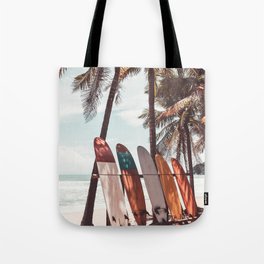 Surfboard and palm tree on the beach. Summer travel sport. Vintage tone filter effect. Tote Bag
