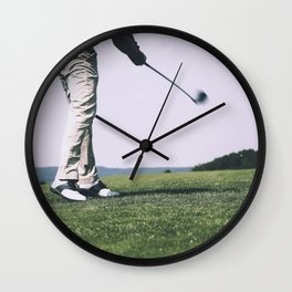 Golfer at a golfcourse Wall Clock