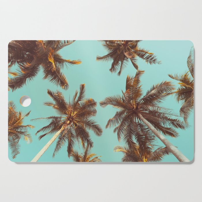 Tropical palm tree with blue sky and cloud abstract background. Summer vacation and nature travel adventure concept. Pastel tone filter effect color style.  Cutting Board