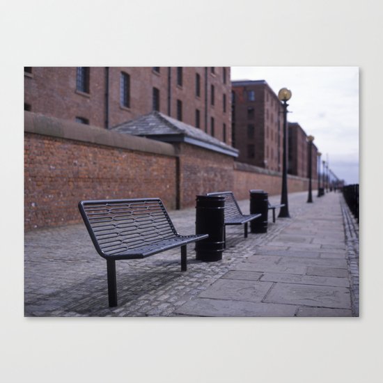 a row of benches Canvas Print
