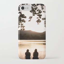 Two girls watching sunset at lake of Banyoles iPhone Case