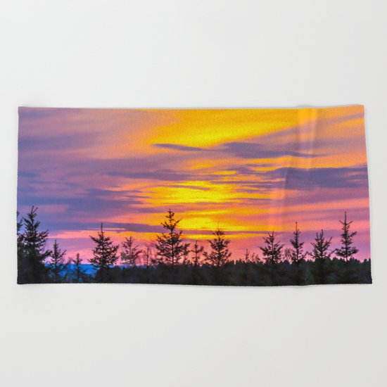 Sunset above the forest Beach Towel