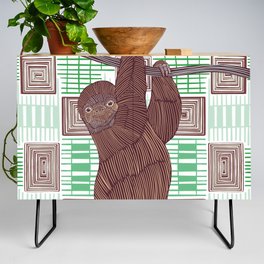 Cute smiling sloth hanging from tree branch Credenza