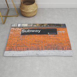 subway sign on a brick wall Area & Throw Rug