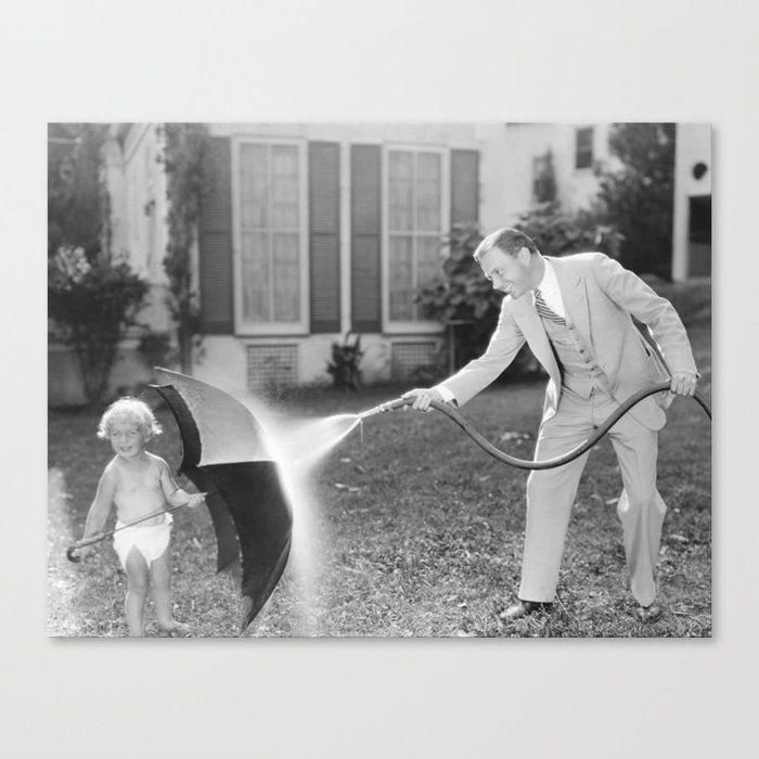 Always look on the bright side of life; little girl thwarting father with hose using umbrella humorous funny black and white photograph - photography - photograph Canvas Print