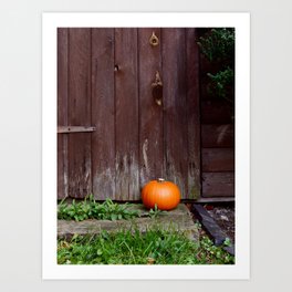 Orange pumpkin by wooden door Art Print