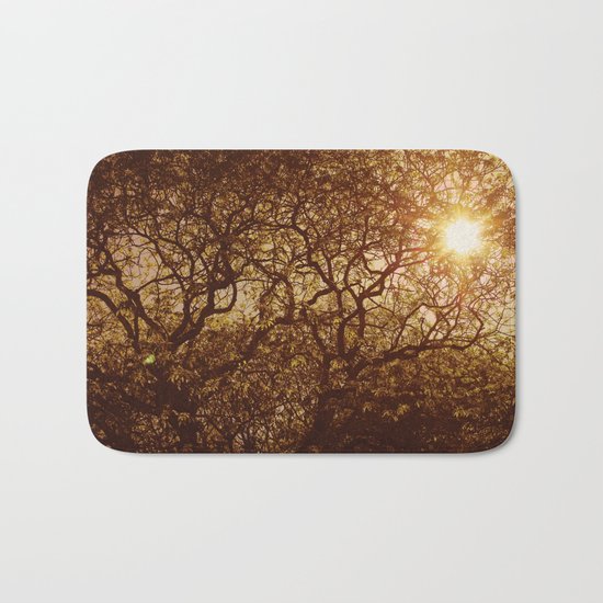 Shining through the trees Bath Mat