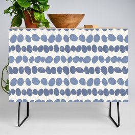 Pebbles - blue pebbles on a string with a cream background Credenza