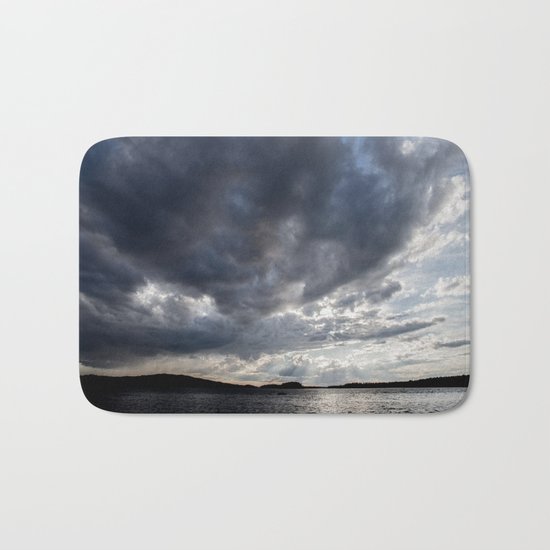 Dark Clouds Coming Over Lake In Scandinavia Bath Mat