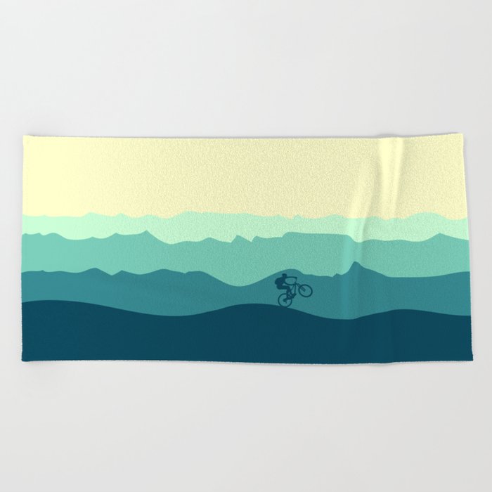 Mountain Biker cycling in the mountains  Beach Towel