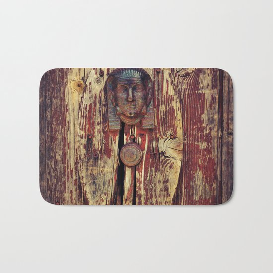 weathered wooden door with agypt door knocker Bath Mat