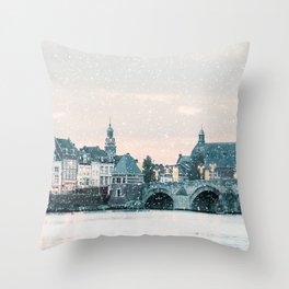 Winter view of the famous Dutch Sint Servaas bridge with lights in the city center of Maastricht Throw Pillow