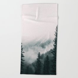 Forest mist beneath the mountain peaks Beach Towel