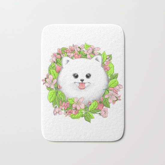 Pomeranian in flowers Bath Mat