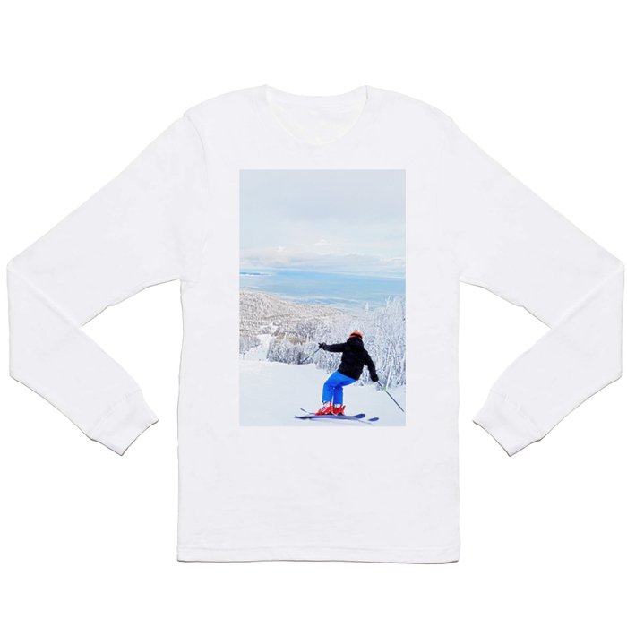 Skier at a ski resort with snowy mountain and lake Long Sleeve T Shirt