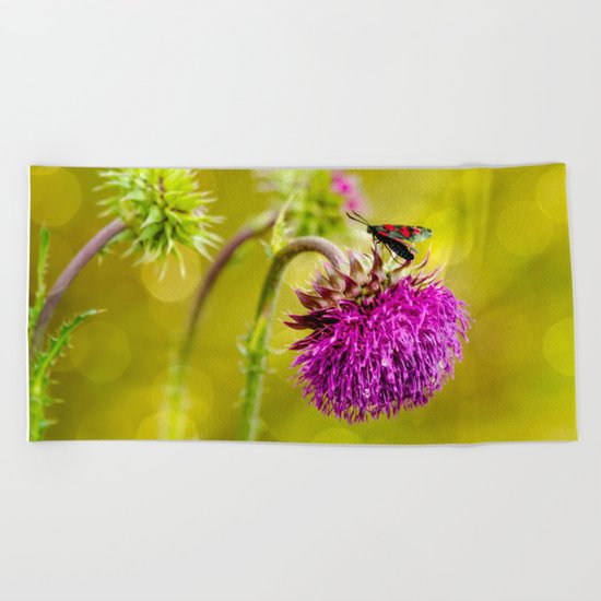 Butterfly and а thistle Beach Towel