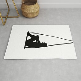 Black silhouette of woman sitting on a swing Rug