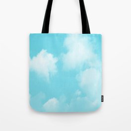 Cute puffy small white clouds on a sunny aqua blue sky Tote Bag
