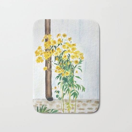 sun choke flowers outside a house Bath Mat