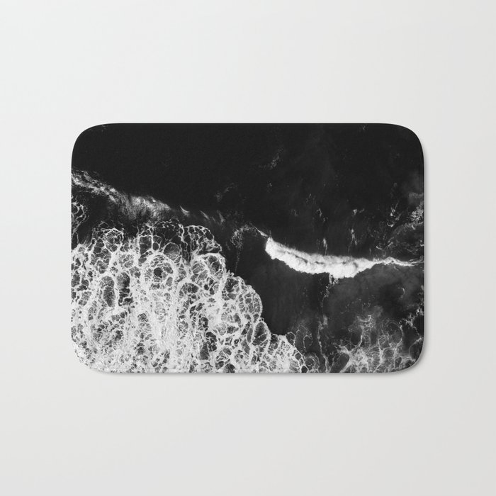 /// Never Alone /// Black and white drone aerial photograph of a dark and moody ocean Bath Mat