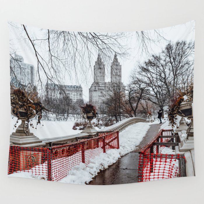 Winter in Central Park in New York City with Bow Bridge covered by snow Wall Tapestry
