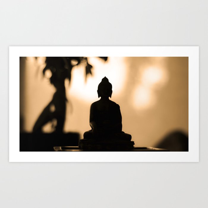 back light silhouette of meditating Buddha statue at sunset - bokeh background - warm colors Art Print