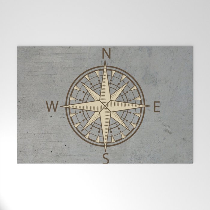 compass on cement background Welcome Mat