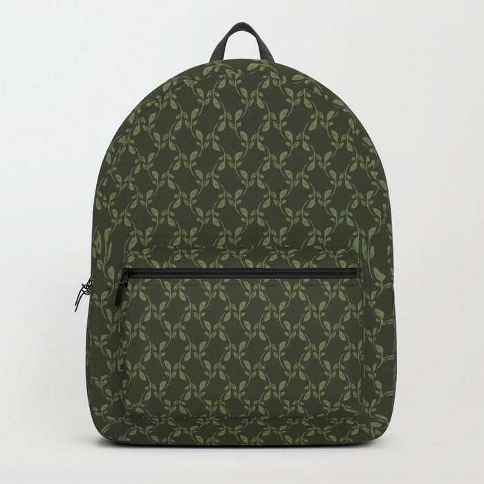Green leaves over dark green background Backpack