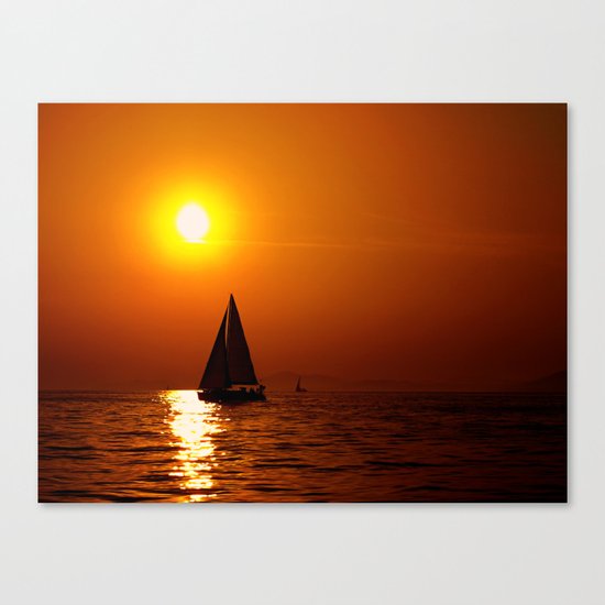 A sailboat at sunset Canvas Print