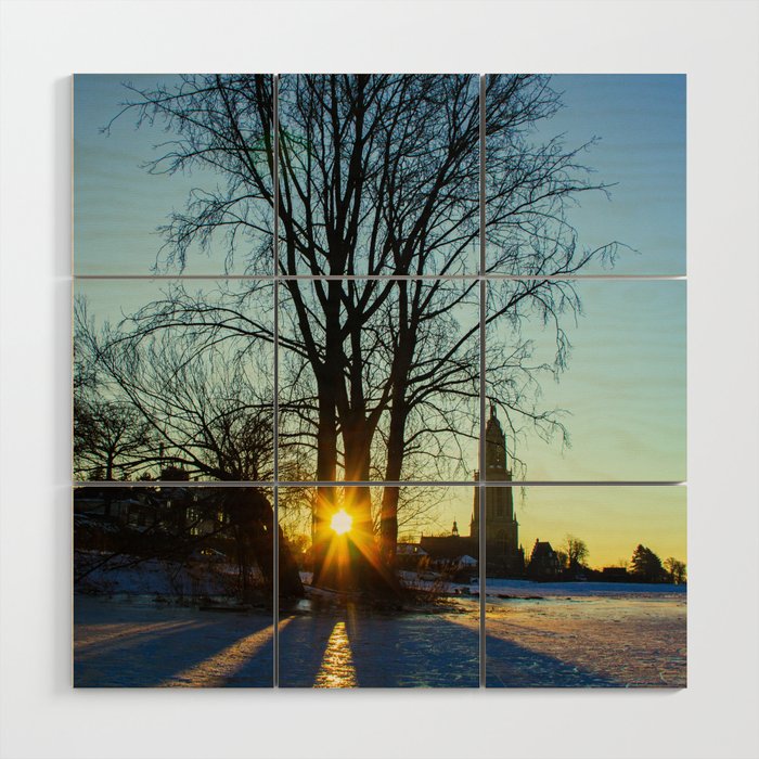 Sunrise on a frozen lake with a little church in the background Wood Wall Art