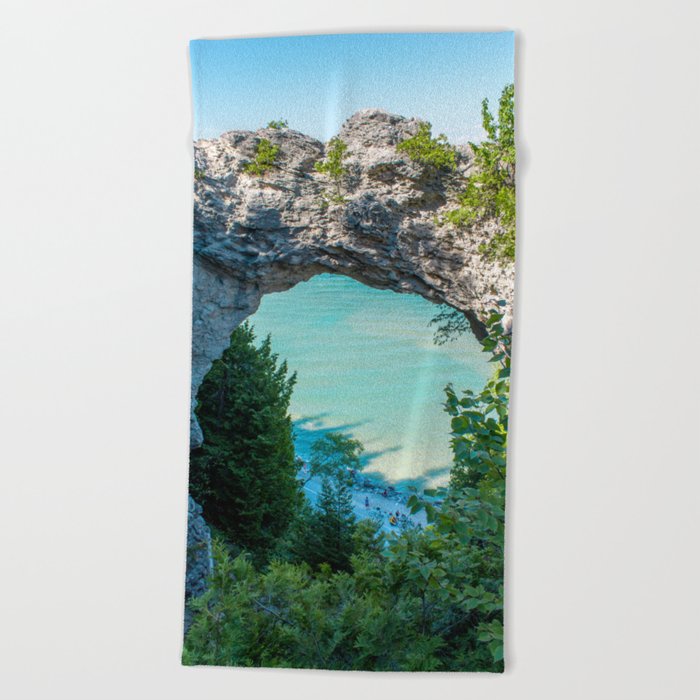 Looking at Lake Michigan through Arch Rock on Mackinac Island in Michigan Beach Towel