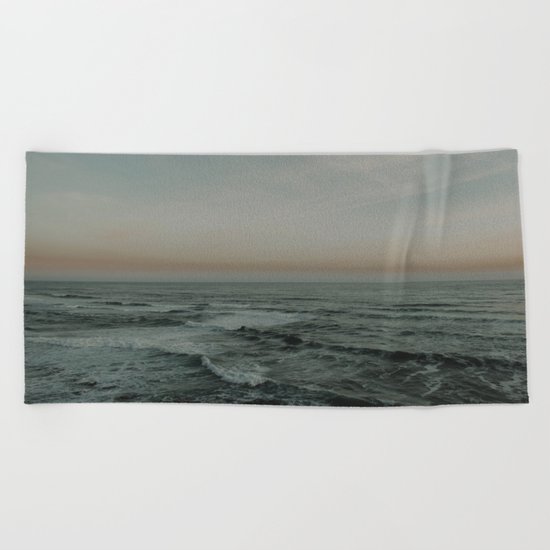 The calm ocean Beach Towel