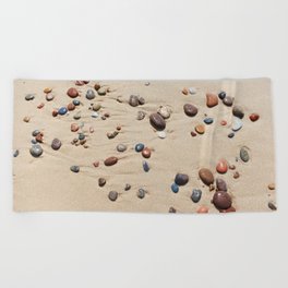 Wet sand and stones on beach Beach Towel
