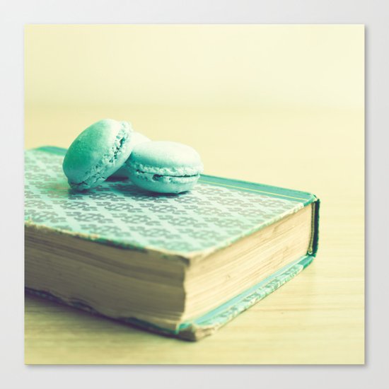 Blue macaroons over book Canvas Print