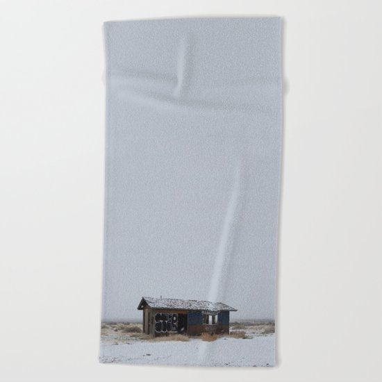 Hopeless, Abandoned, and Alone Under Grey Snow Filled Sky Beach Towel