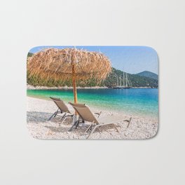 Kefalonia, Greece. Beach chair and umbrella at the Antisamos beach. Bath Mat