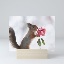 squirrel holding a winter rose Mini Art Print